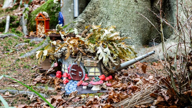 A watering can house on the woodland fairy trail